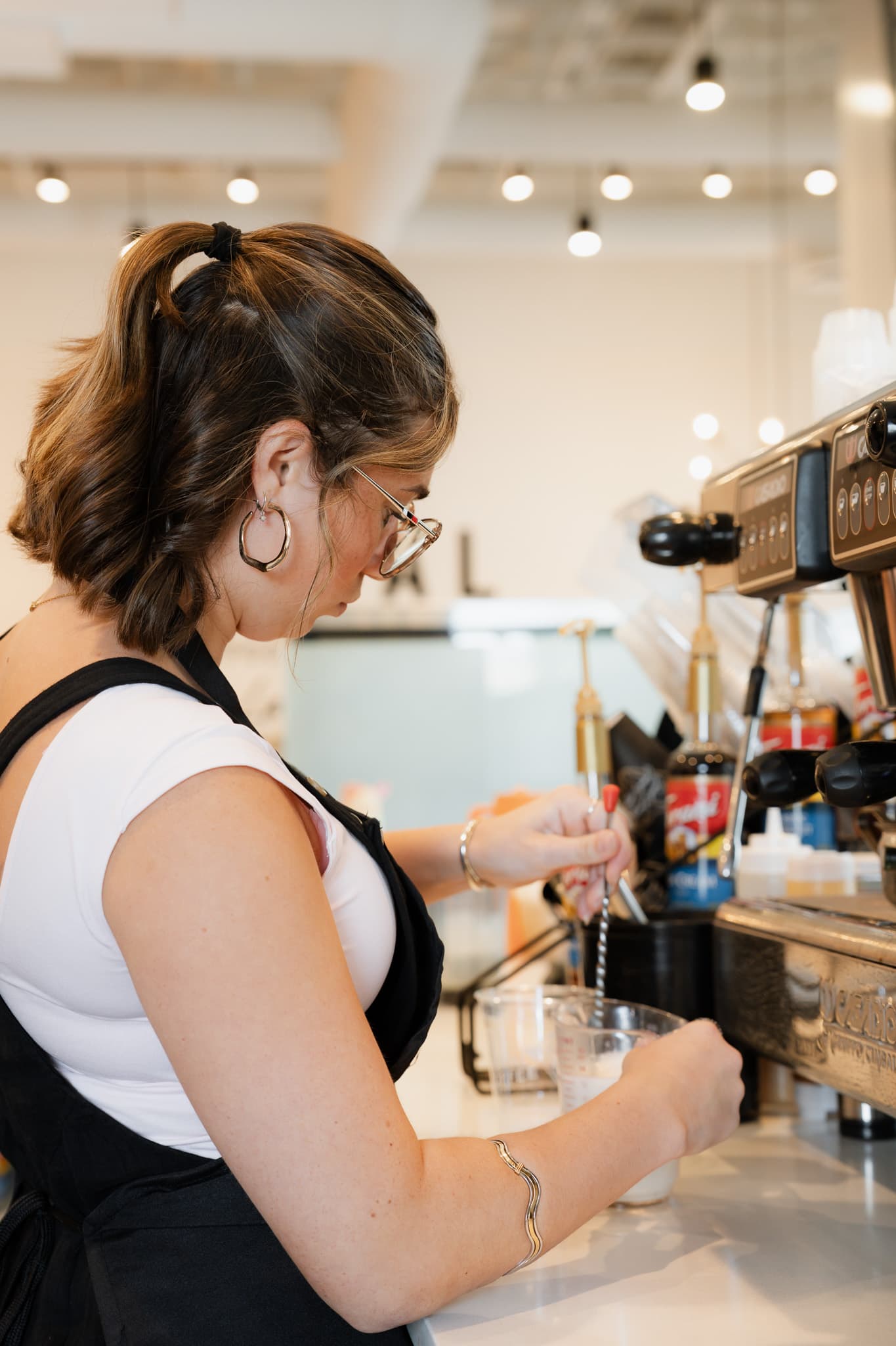 Barista crafting a drink at the espresso machine